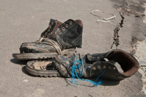 Old worn out broken leather boots.